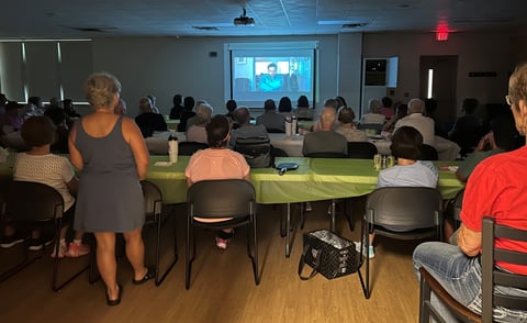  room with patrons watching a movie